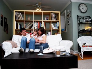 parents with baby on couch