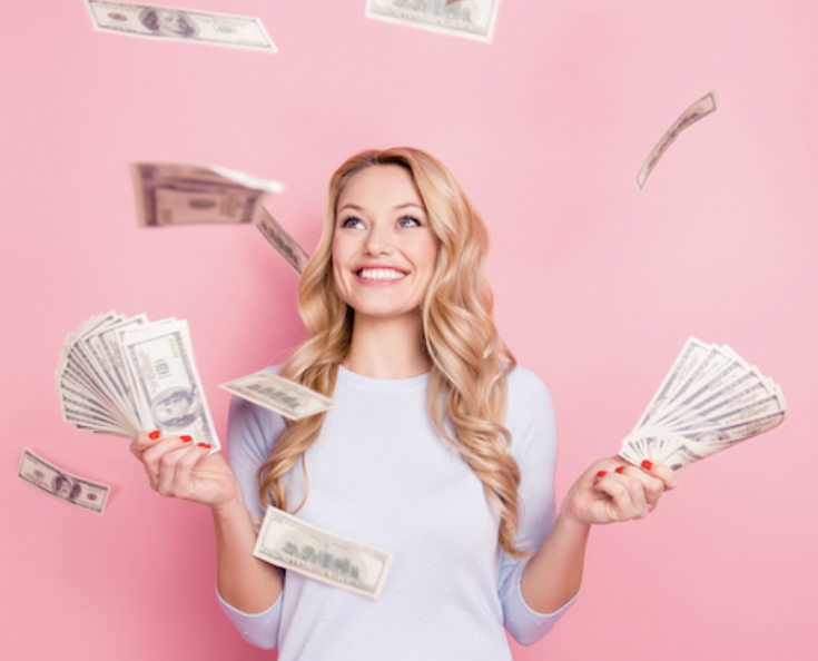 A woman holding a lot of money in her both hands with big smile 