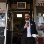 NYC Mayer standing in front of restaurant