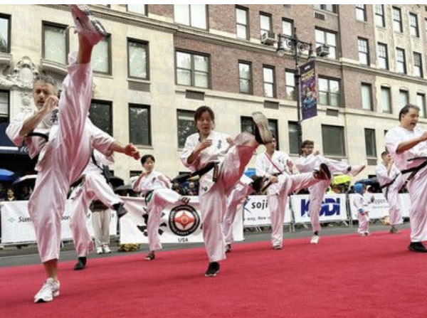 Performers on the red carpet in the rain