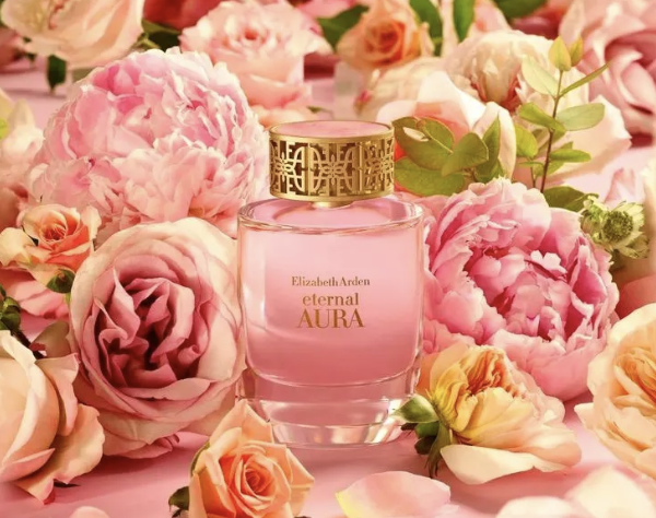 Woman perfume with a lot of flowers as a background